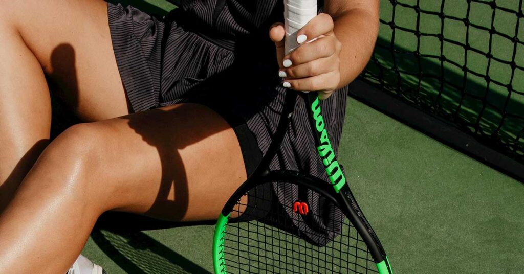 a girl holding a tennis racket